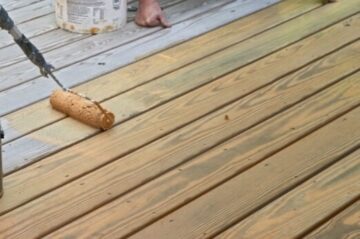 A wooden deck being stained with ZAR® Deck & Siding Semi-Transparent Stain.