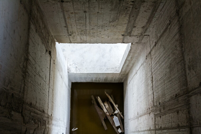 This is an image looking down into a concrete elevator pit.